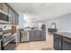 The kitchen has stainless steel appliances, granite countertops, and plenty of cabinet space overlooking the main living area at 13643 Tramore Dr, Odessa, FL 33556