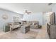Comfortable living room with a sectional sofa, ceiling fan, and a decorative trunk as a coffee table at 13643 Tramore Dr, Odessa, FL 33556