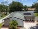 Aerial view of a home with solar panels, a freshly sealed driveway, and a screened-in pool at 13835 Pathfinder Dr, Tampa, FL 33625