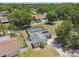 A bird's eye view of home, highlighting its screened-in pool, solar panels, and cozy backyard setting at 13835 Pathfinder Dr, Tampa, FL 33625