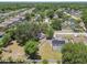 An aerial view of a community showcases a house with a screened pool and solar panels on its roof at 13835 Pathfinder Dr, Tampa, FL 33625
