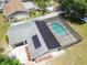 Aerial view of solar panels and a screened-in pool in the backyard of a well-maintained single Gathering home at 13835 Pathfinder Dr, Tampa, FL 33625
