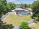This spacious backyard includes a screened pool, solar panels and a white privacy fence at 13835 Pathfinder Dr, Tampa, FL 33625