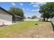 Spacious backyard featuring healthy green lawn, privacy fence and a screened in pool at 13835 Pathfinder Dr, Tampa, FL 33625