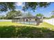Private backyard featuring a screened in pool, a lush lawn, and a white privacy fence at 13835 Pathfinder Dr, Tampa, FL 33625
