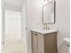 Modern bathroom with a stylish vanity, quartz countertop, and view into hallway at 13835 Pathfinder Dr, Tampa, FL 33625