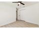 Bedroom showcasing light wood flooring, a ceiling fan, closet, and white trim at 13835 Pathfinder Dr, Tampa, FL 33625