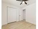 Bedroom showcasing light wood flooring, a ceiling fan, closet, and white trim at 13835 Pathfinder Dr, Tampa, FL 33625