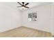 Bright bedroom features light wood flooring, a ceiling fan, and a window with natural light at 13835 Pathfinder Dr, Tampa, FL 33625