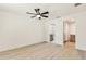 Bright bedroom with a ceiling fan, hardwood floors, and ensuite bathroom at 13835 Pathfinder Dr, Tampa, FL 33625