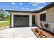 Home featuring a newly landscaped front yard, a driveway, and an attached garage at 13835 Pathfinder Dr, Tampa, FL 33625