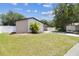 Landscaped front yard with healthy green grass, palm tree and white fence at 13835 Pathfinder Dr, Tampa, FL 33625