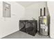 Garage featuring washer, dryer, and water heater on painted floor with white walls at 13835 Pathfinder Dr, Tampa, FL 33625
