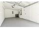 Clean garage space with painted floor, storage, and utility connections at 13835 Pathfinder Dr, Tampa, FL 33625