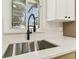 Kitchen sink features a modern black faucet and a view to the backyard at 13835 Pathfinder Dr, Tampa, FL 33625