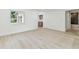 Bright living room featuring light wood floors, white walls, and lots of natural light from the window at 13835 Pathfinder Dr, Tampa, FL 33625
