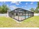 Backyard screened-in pool with stone patio, perfect for swimming and relaxation at 13835 Pathfinder Dr, Tampa, FL 33625