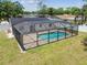 Aerial view of a screened pool and brick-paved patio surrounded by a black frame at 13835 Pathfinder Dr, Tampa, FL 33625