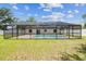 Private screened-in backyard pool with well-maintained lawn, ideal for summer fun and relaxation at 13835 Pathfinder Dr, Tampa, FL 33625