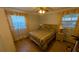Cozy bedroom with hardwood floors, a ceiling fan and two windows at 1538 S Lake Ave, Clearwater, FL 33756