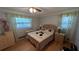 Bright bedroom with hardwood floors, a ceiling fan and two windows at 1538 S Lake Ave, Clearwater, FL 33756