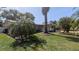 Well-maintained home with lush landscaping, mature palm trees, and a welcoming entrance at 1538 S Lake Ave, Clearwater, FL 33756