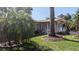 Beautifully landscaped front yard with mature trees and a charming home entrance featuring a white picket fence at 1538 S Lake Ave, Clearwater, FL 33756