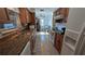 Functional kitchen with oak cabinets, granite counters, and white appliances at 1538 S Lake Ave, Clearwater, FL 33756