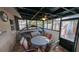 Screened patio with a ceiling fan and comfortable seating, perfect for outdoor dining at 1538 S Lake Ave, Clearwater, FL 33756
