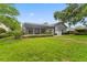 Spacious backyard with lush green grass and mature landscaping at 15615 Indian Queen Dr, Odessa, FL 33556