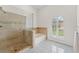 Bathroom featuring a separate tub and shower with a tiled surround and a window at 15615 Indian Queen Dr, Odessa, FL 33556