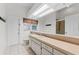The bathroom features a long countertop, cabinets, a toilet, and a glass-enclosed shower at 15615 Indian Queen Dr, Odessa, FL 33556