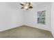 An airy bedroom featuring a ceiling fan and a sunlit window at 15615 Indian Queen Dr, Odessa, FL 33556