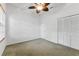 Neutral bedroom with a ceiling fan, closet, and a sunlit window at 15615 Indian Queen Dr, Odessa, FL 33556
