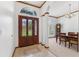Elegant entryway featuring tile flooring, a wooden door, and a dining area at 15615 Indian Queen Dr, Odessa, FL 33556
