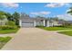 Exterior shot of a well-maintained home with a spacious driveway and lush landscaping at 15615 Indian Queen Dr, Odessa, FL 33556