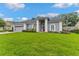 A beautiful single-story home with arched windows and a well-kept green lawn at 15615 Indian Queen Dr, Odessa, FL 33556