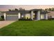 Charming single-story home featuring a manicured lawn and a gray stucco exterior at 15615 Indian Queen Dr, Odessa, FL 33556