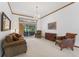 Bright living room with comfortable seating, a chandelier, and a backyard view at 15615 Indian Queen Dr, Odessa, FL 33556