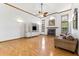 Open living room with hardwood floors, brick fireplace, custom built-ins, and natural lighting at 15615 Indian Queen Dr, Odessa, FL 33556