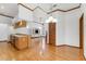 Open living space with wood floors, high ceilings, fireplace, and pass-through kitchen at 15615 Indian Queen Dr, Odessa, FL 33556