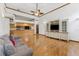Open living space with hardwood floors, custom built-ins, and an open view to the kitchen at 15615 Indian Queen Dr, Odessa, FL 33556