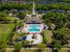 Aerial view of the community amenities center, showcasing the pool, playground, and lush green spaces for recreation at 17510 Bright Wheat Dr, Lithia, FL 33547