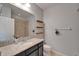 Bright bathroom featuring granite counters, a large mirror, and a shower with neutral tile surround at 17510 Bright Wheat Dr, Lithia, FL 33547