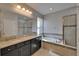 Bathroom with dual vanity, soaking tub, and separate tiled shower at 17510 Bright Wheat Dr, Lithia, FL 33547