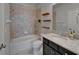 Bathroom featuring granite vanity top, tiled shower and tub combo, and tile floors at 17510 Bright Wheat Dr, Lithia, FL 33547