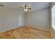 Spacious bedroom with hardwood flooring, ceiling fan, and window with blinds at 17510 Bright Wheat Dr, Lithia, FL 33547