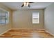 This bright bedroom has a ceiling fan, a window, and wood flooring at 17510 Bright Wheat Dr, Lithia, FL 33547