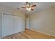 Bedroom featuring hardwood flooring, a ceiling fan with light and a closet at 17510 Bright Wheat Dr, Lithia, FL 33547