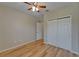 Bedroom featuring hardwood floors, a closet, and a ceiling fan at 17510 Bright Wheat Dr, Lithia, FL 33547
